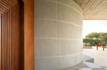 Brutalist and rural aesthetics weave into the bageecha farmhouse in india