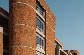 Rigid and curved brick volumes collide at girl’s nursing college & hostel in india