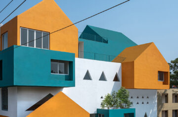 Projected cantilevers and recessed windows in vibrant hues shape school in india