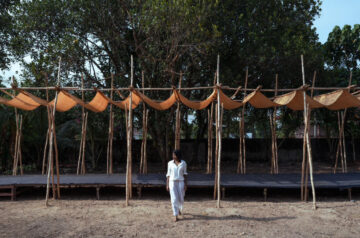 Tensile fabric weaves through studio terratects’ wooden trestle pavilion in india